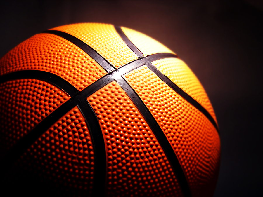 orange basketball against a dark background composed horizontally